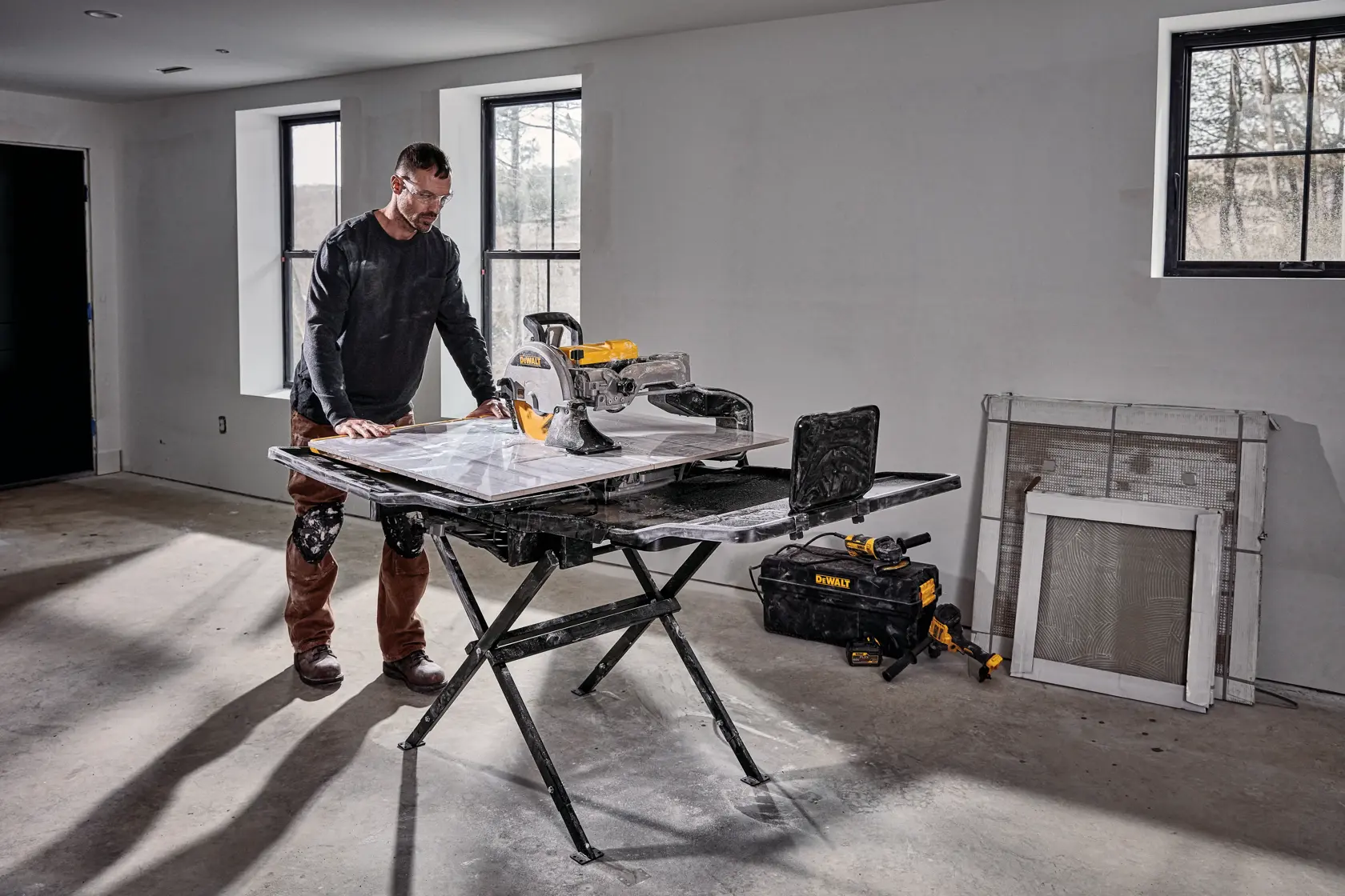 DEWALT D36000-QS, D36000 tile saw on stand in use indoors. Photography category. Tools and accessories visible.