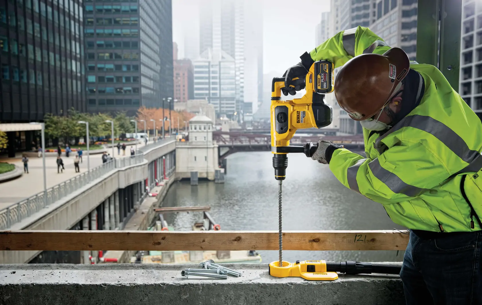 Photo of DEWALT rotary hammer DCH481X2, DCH481X2-GB drilling concrete on a city construction site.