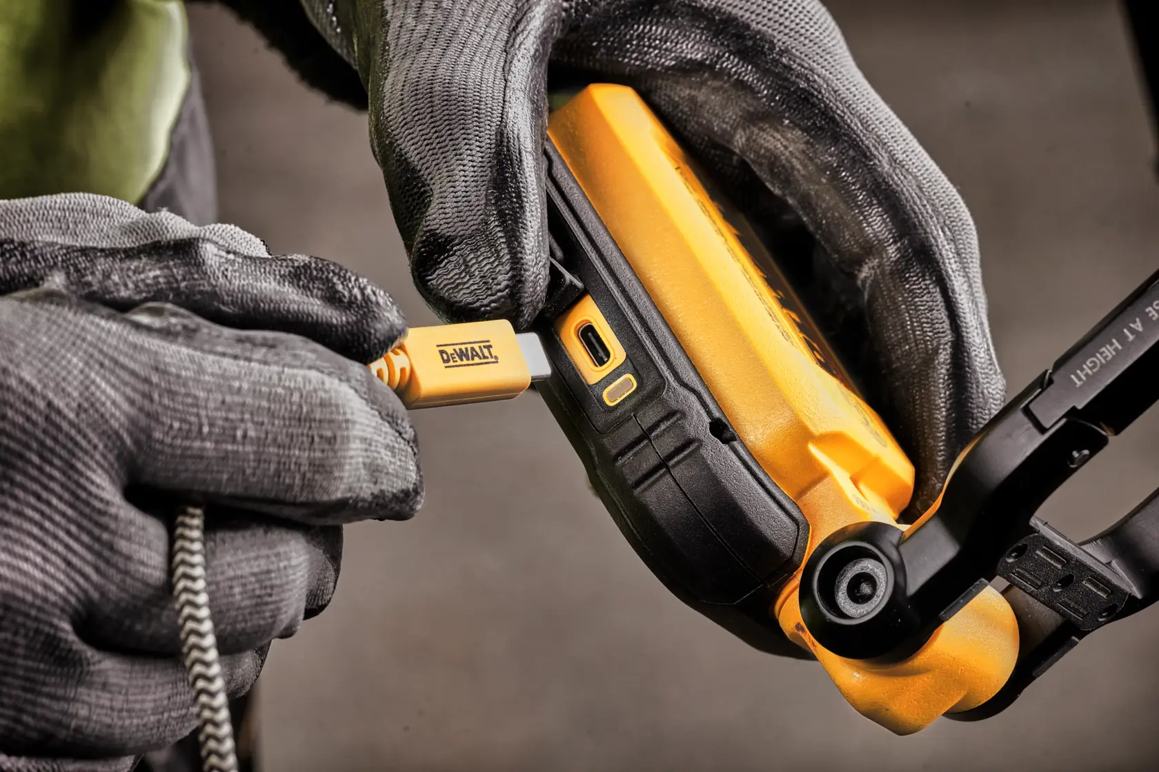 A DEWALT portable LED work light with a black and yellow casing, featuring a rectangular light panel with multiple LEDs and a foldable stand.