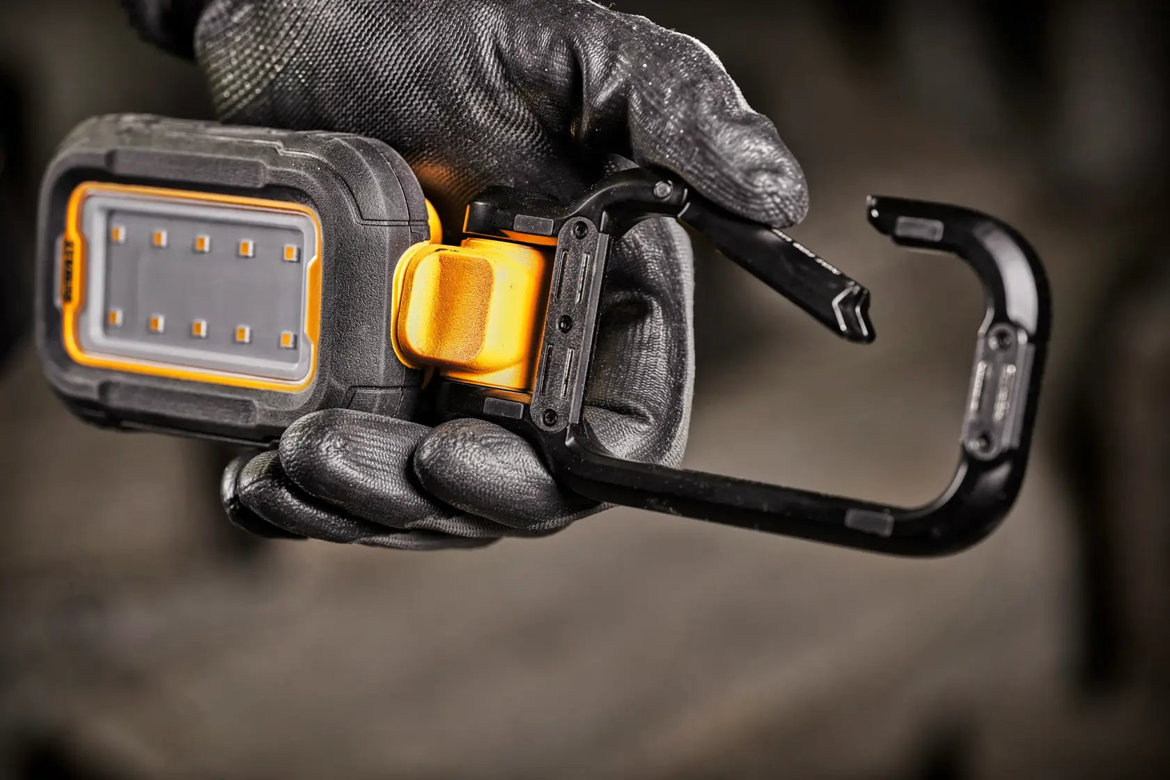 A DEWALT DCL182 portable LED work light with a rugged black and yellow casing, adjustable stand, and multiple LED bulbs, shown against a white background.