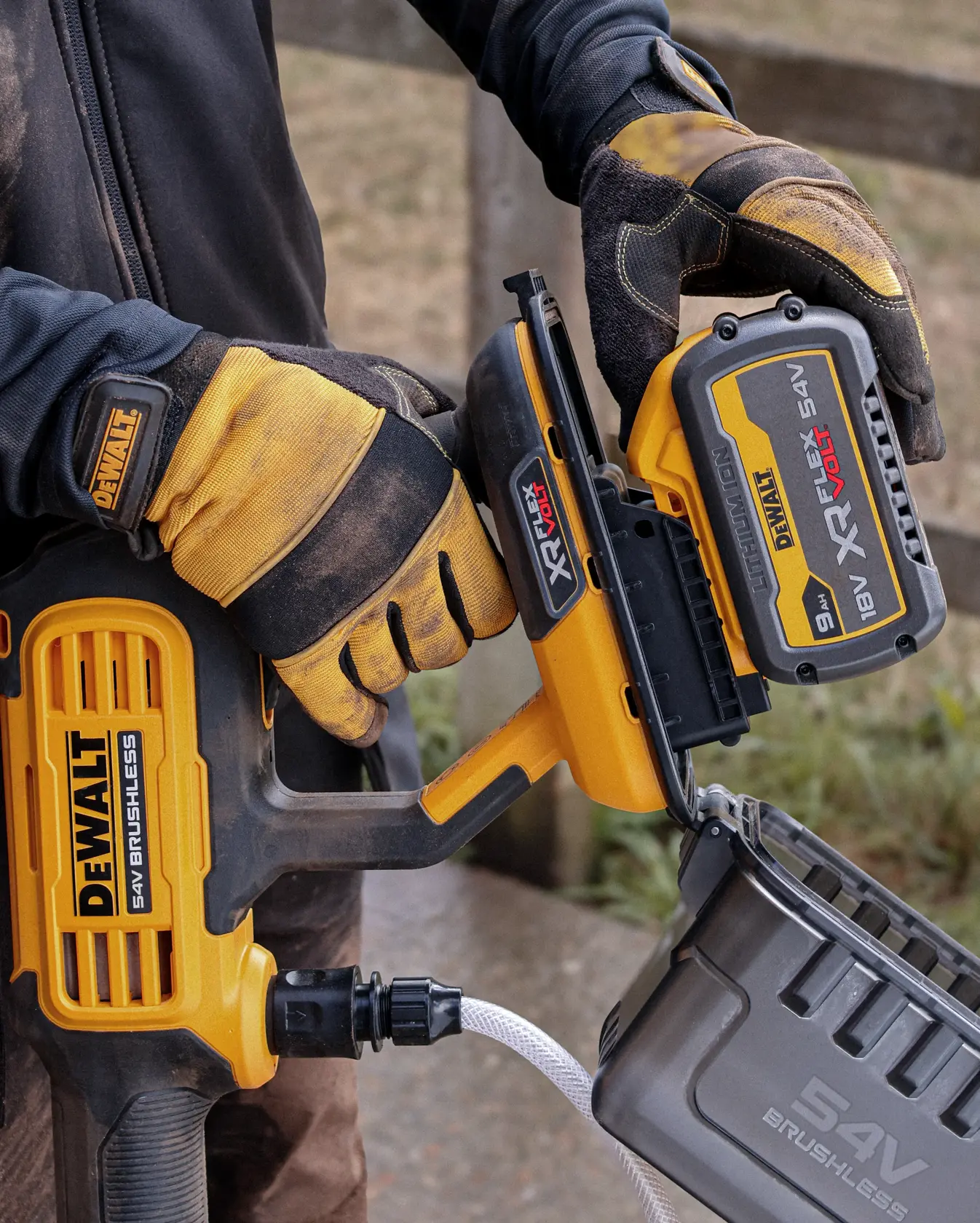 DEWALT DCMPW1000N, DCMPW1000N-XJ brushless tool in use outdoors, close up of battery being attached.