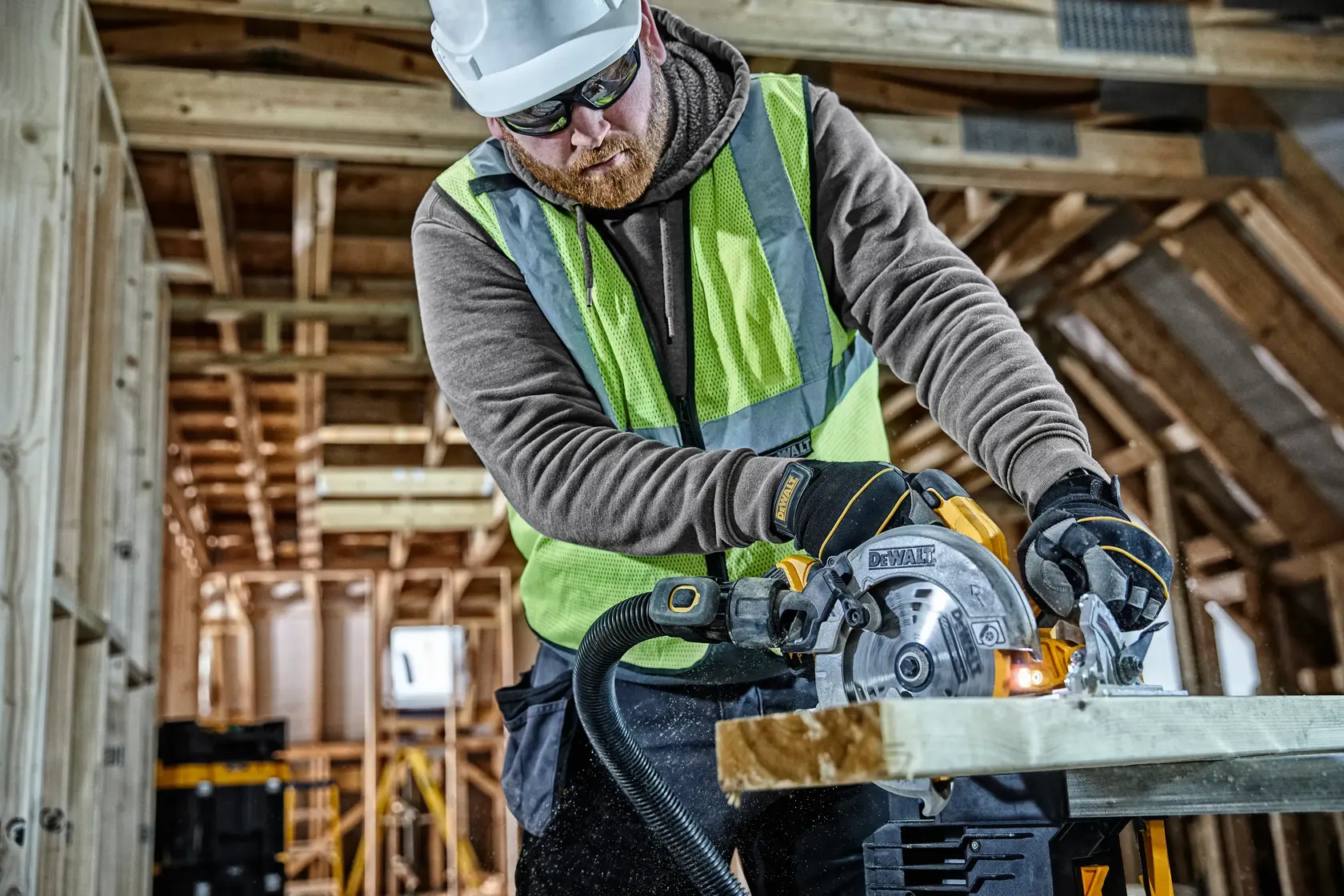Photo of worker using DEWALT saw, SKUs DCS570, DCS570NT-XJ, DCS570NT, in construction site.
