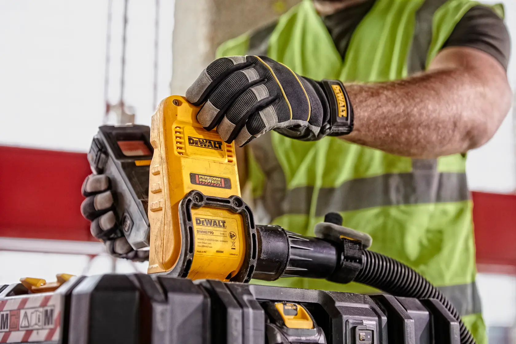Front view of a DEWALT DWH079D dust box evacuator, a photography accessory with a yellow body, black accents, and warning labels.