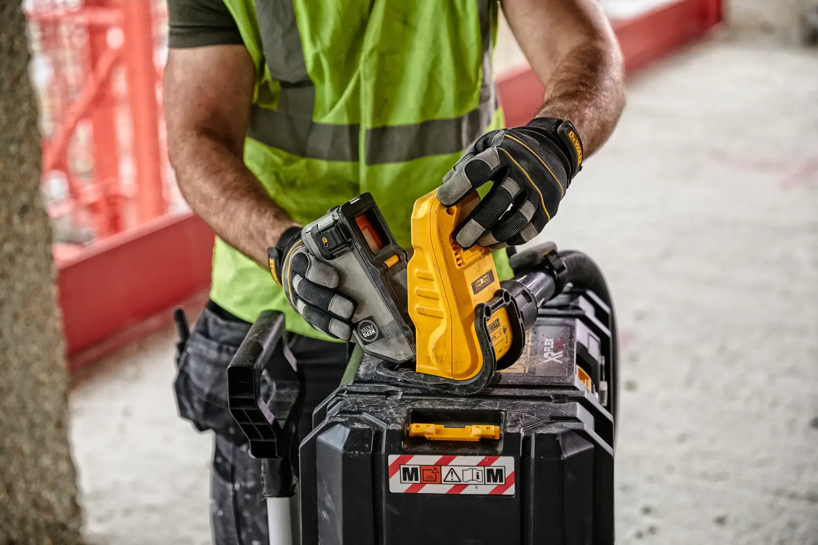 Front view of a DEWALT DWH079D dust box evacuator, a photography accessory with a yellow body, black accents, and warning labels.