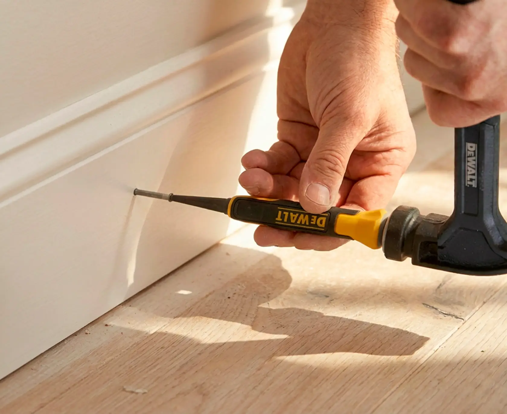 Three DEWALT hand tools with flared yellow and black grips are shown side by side. The text below states: 'FLARED GRIP helps to protect hand against glancing blows.'