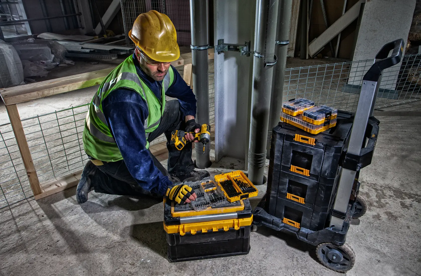 A DEWALT rolling trolley platform with a black plastic base, silver metal frame, and four caster wheels. The platform features locking mechanisms and a raised handle for transporting heavy items.